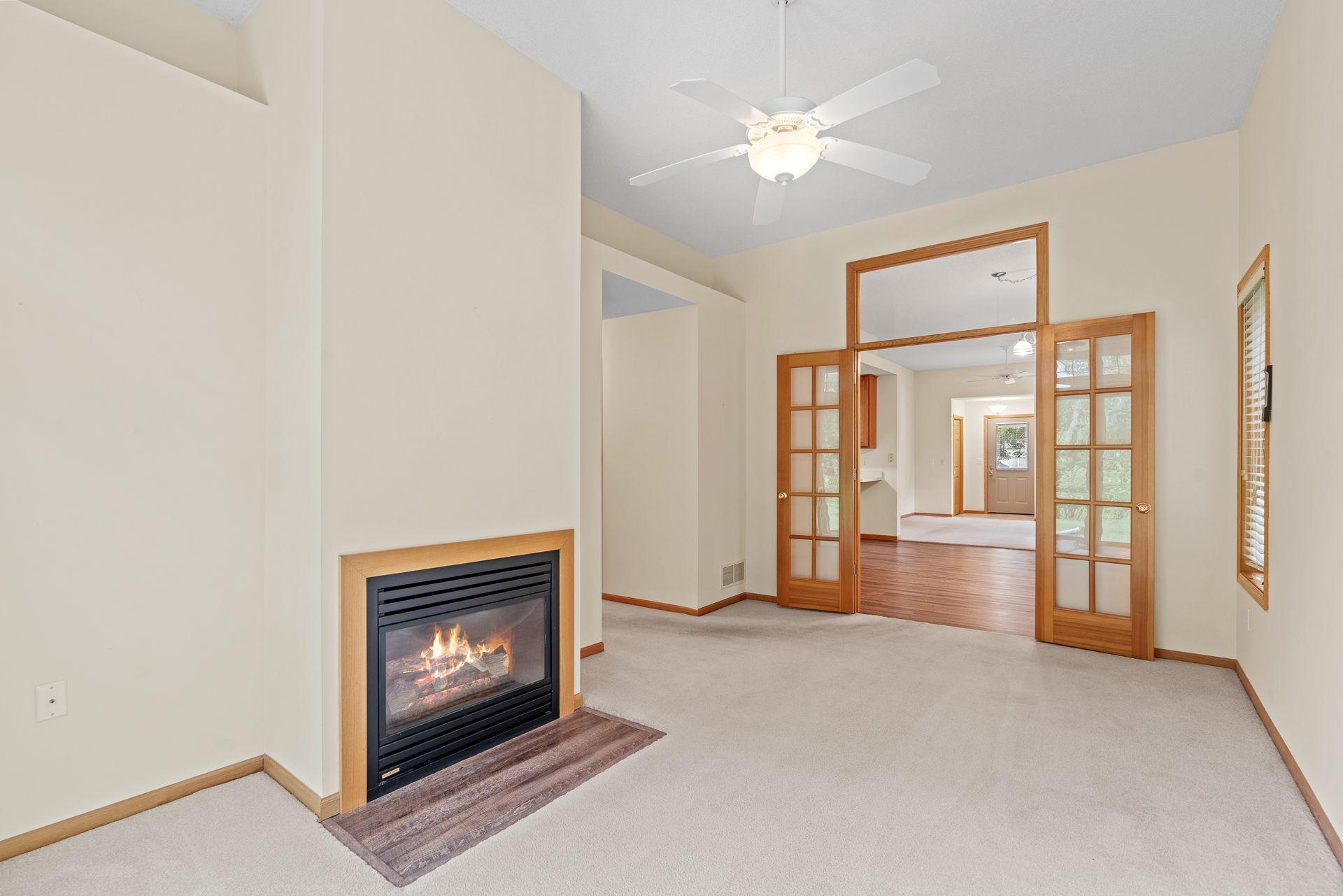 Fireplace in living room with beautiful french doors
