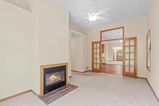 Fireplace in living room with beautiful french doors