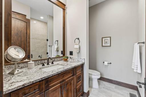 The ensuite bath offers heated tile floors and an ADA-accessible walk-in shower.