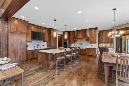 At the heart of the home, the chefâs kitchen is a masterpiece of design and function. Alder cabinetryâmilled on site and finished with a custom stainâpairs with granite countertops, double ovens, and high-end Thermador appliances throughout.