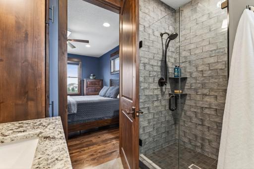 It has its own Â¾ ensuite bath with a beautifully tiled walk-in shower.