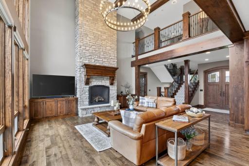 Rich hickory wood flooring and impeccable millwork add timeless elegance, and ten-foot ceilings carry throughout the main level, enhancing the sense of openness and light.