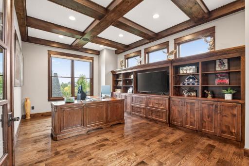 Just off the entry, the main-level office is enclosed by custom French doors and elevated with a full wall of Alder built-ins and wood-beam ceiling accentsâa refined space to work or study.
