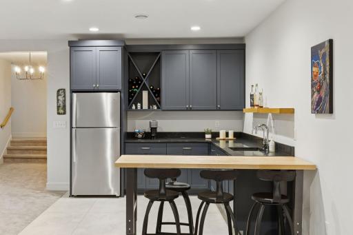 The lovely wet bar with enameled cabinetry and dedicated reverse-osmosis faucet is the perfect place to entertain.