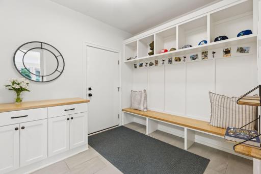 The ideal mudroom for busy people! Room to corral everyone's gear (not pictured here is an additional walk in closet). The drop zone on the left side of the photo features hidden outlets for easy device charging, too.
