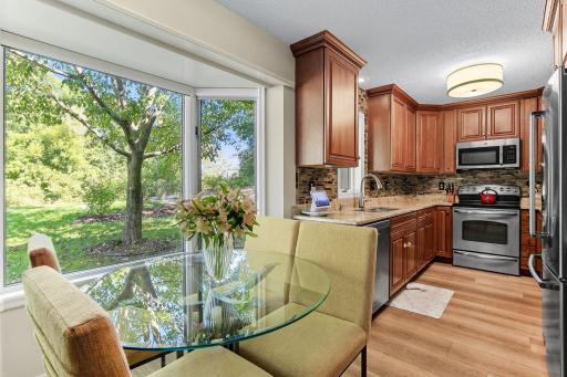 Welcome to this charming 3 bed 3 bath Mendota Heights home. This end-unit townhome features a spacious main level with a bright kitchen, complete with wood cabinetry, granite countertops, and stainless steel appliances.