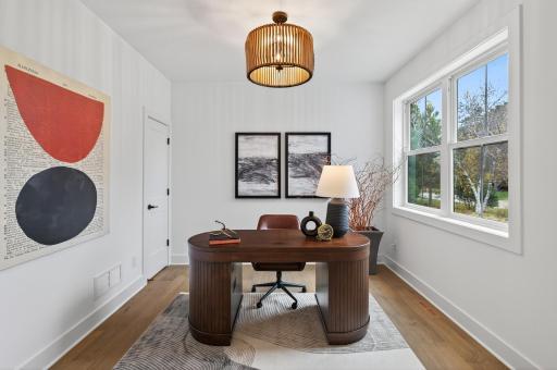 A versatile main-floor bedroom with elegant pocket doors offers a private retreat for guests or an inspiring setting for a home office or library.
