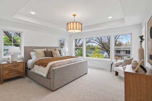 Upstairs, the primary suite redefines luxury living. Beyond the graceful French doors awaits a serene sanctuary.