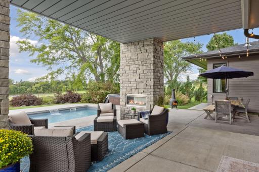 Exceptional backyard space with covered porch, 2 fireplaces, pool and putting green