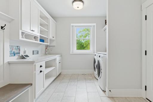 Spacious mud room/laundry room with great storage and large bench