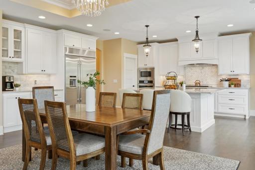 Spacious dining area features a built in bench and display cabinets with accent lighting