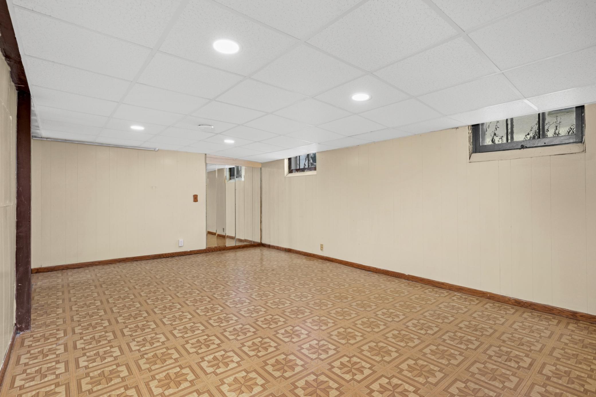 Geometric vinyl flooring and recessed lighting