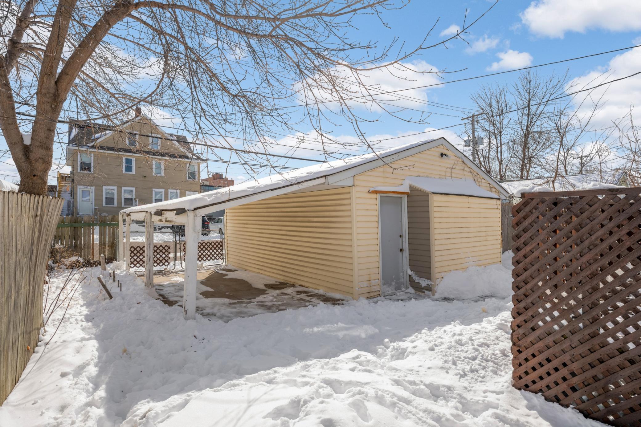 Oversized 2-car garage with covered carport for weather protection