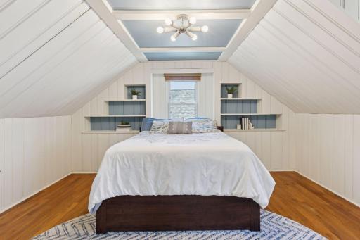 Nice sized upper level Primary Bedroom Suite with built-in shelving and hardwood floors