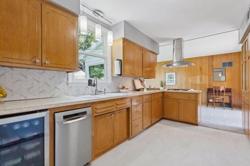 Newer dishwasher, mini fridge, backsplash and lighting.