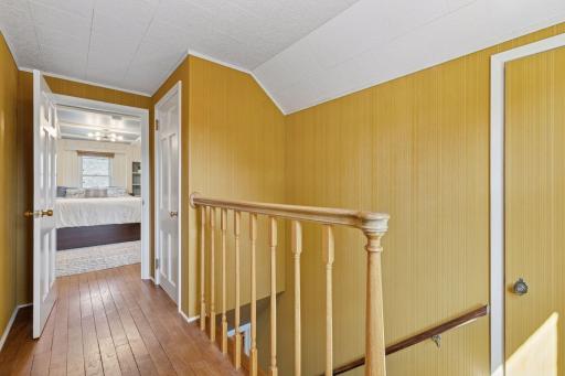 Upper level hallway with attic storage closets