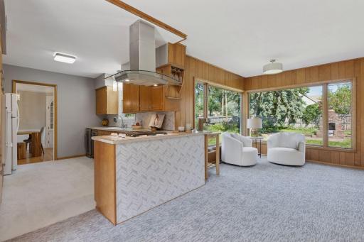 Mini great room feel Den that brings in all the light to enjoy all year round - the jewel of the home featuring brand new carpeting.