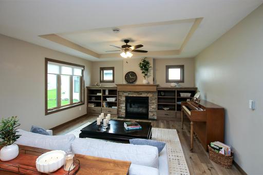Heated floors throughout, cozy gas fireplace accented by real stone and built-in shelving