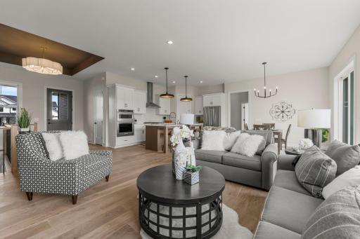 The open-concept main floor welcomes you with engineered hardwood floors that flow throughout, accentuating the 10-foot ceilings and enhancing the sense of space and light.