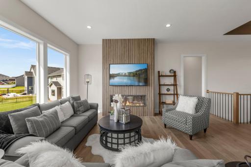 All of this flows effortlessly into the expansive great room where an electric fireplace serves as a cozy focal point.