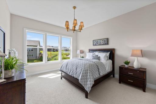 The main-level primary suite is a private retreat, thoughtfully designed for comfort and convenience.
