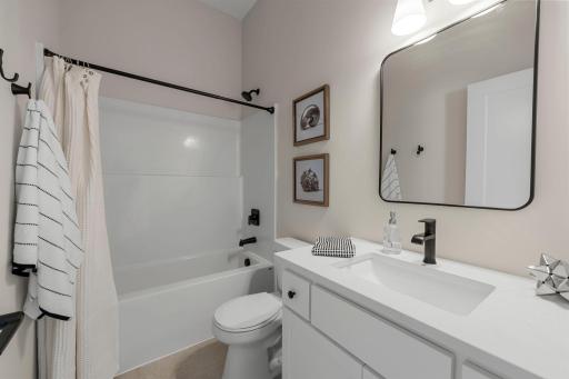 The second bedroom is serviced by a well-appointed full bathroom, perfect for guests.
