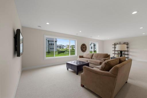 Descend to the finished walkout lower level, where a large family room offers the perfect space for movie nights, game days, or casual relaxation.
