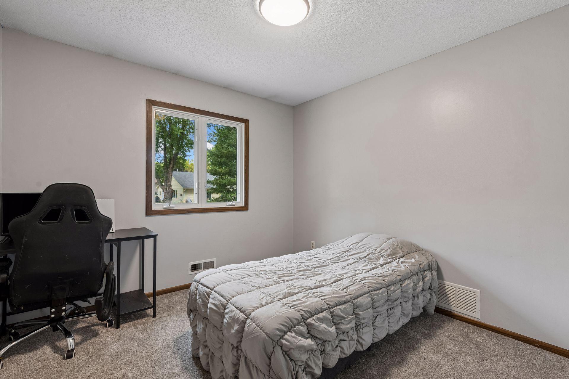 Upper level second bedroom with new carpet, paint and light fixture.