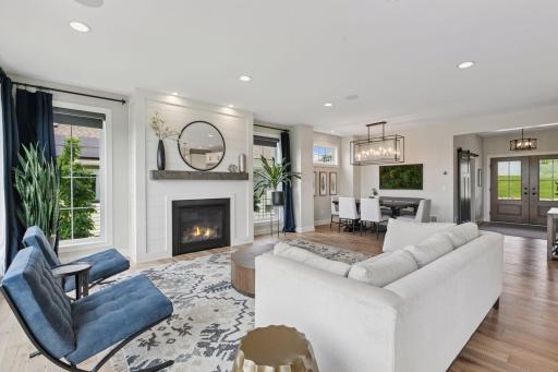 The living room is centered around a contemporary fireplace that brings both warmth and an inviting ambiance to the space.