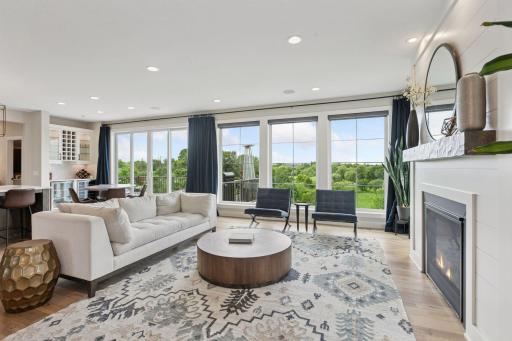 Oversized windows flood the space with natural light and showcase stunning views of the backyard and beyond.