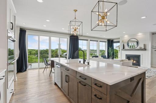 An expansive kitchen island provides casual seating along with extra storage and prep space.