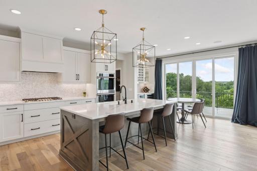 Crisp white cabinetry, a beautiful backsplash, and modern pendant light fixtures are all features you're guaranteed to love in this kitchen!