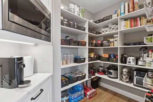 The spacious walk-in pantry offers abundant storage and smart organization solutions.