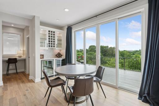 The informal dining area is perfect for casual meals and walks out to the deck.
