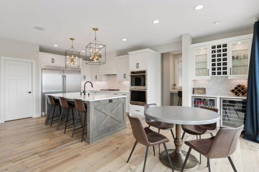 Notice the kitchen bar, a stylish and functional centerpiece ideal for entertaining guests, or enjoying your morning coffee.