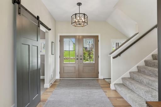 Grand double entry doors create a stunning first impression and invite you into the home with elegance.