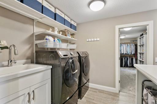 The walk-in closet offers convenient access directly to the upper level laundry.