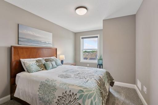 The third upstairs bedroom has neutral carpeting and paint, and convenient access to the Jack-and-Jill bathroom.