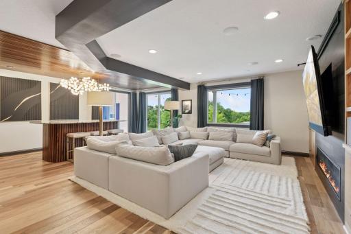 The walk-out lower level features recessed lighting and a large window, creating a bright and welcoming atmosphere.
