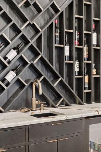 Incredible wine rack wall compliments the custom wet bar, featuring a beverage center.