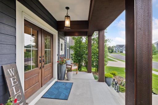 Inviting covered front porch with rich timber columns and peaceful neighborhood views creating yet another outdoor relaxation space.