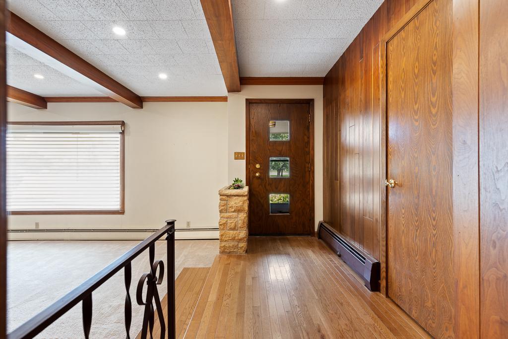 Step inside and be greeted by warm, inviting hardwood flooring and showstopping wood beams