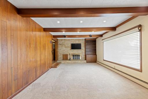 Recessed lighting nicely contrasts the dark wood beams