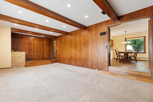A wide doorway opens up to the dining room and kitchen