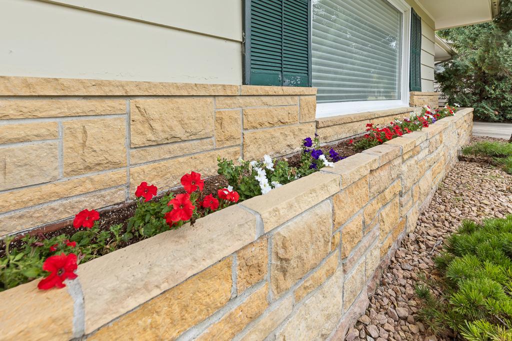 Thoughtful details shine through with built-in stone flower beds, adding charm and color to the home’s timeless curb appeal