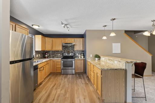 New gleaming flooring in the kitchen. Great cabinet space, even space for a coffee bar.