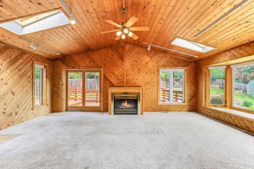 Amazing Great Room!! Bump-out add on to this split creates a large great room on the main level along with a separate living room! Vaulted wood ceiling with tons of natural light and direct access to the decks!