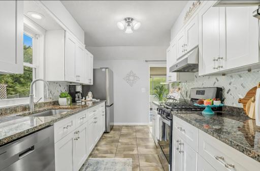 Fabulous fully remodeled kitchen; new cabinets, SS appliances, granite counter tops.