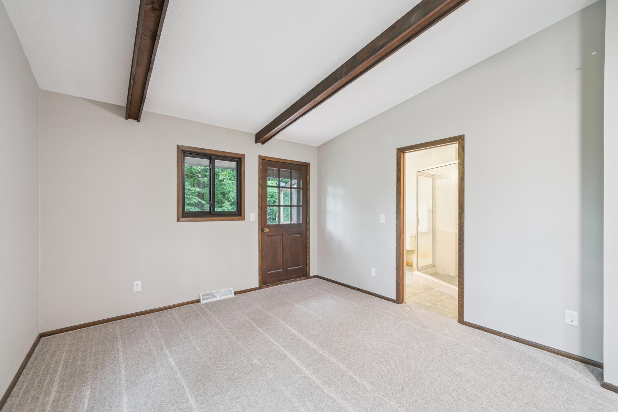 Primary bedroom with access to private deck and 3/4 bath