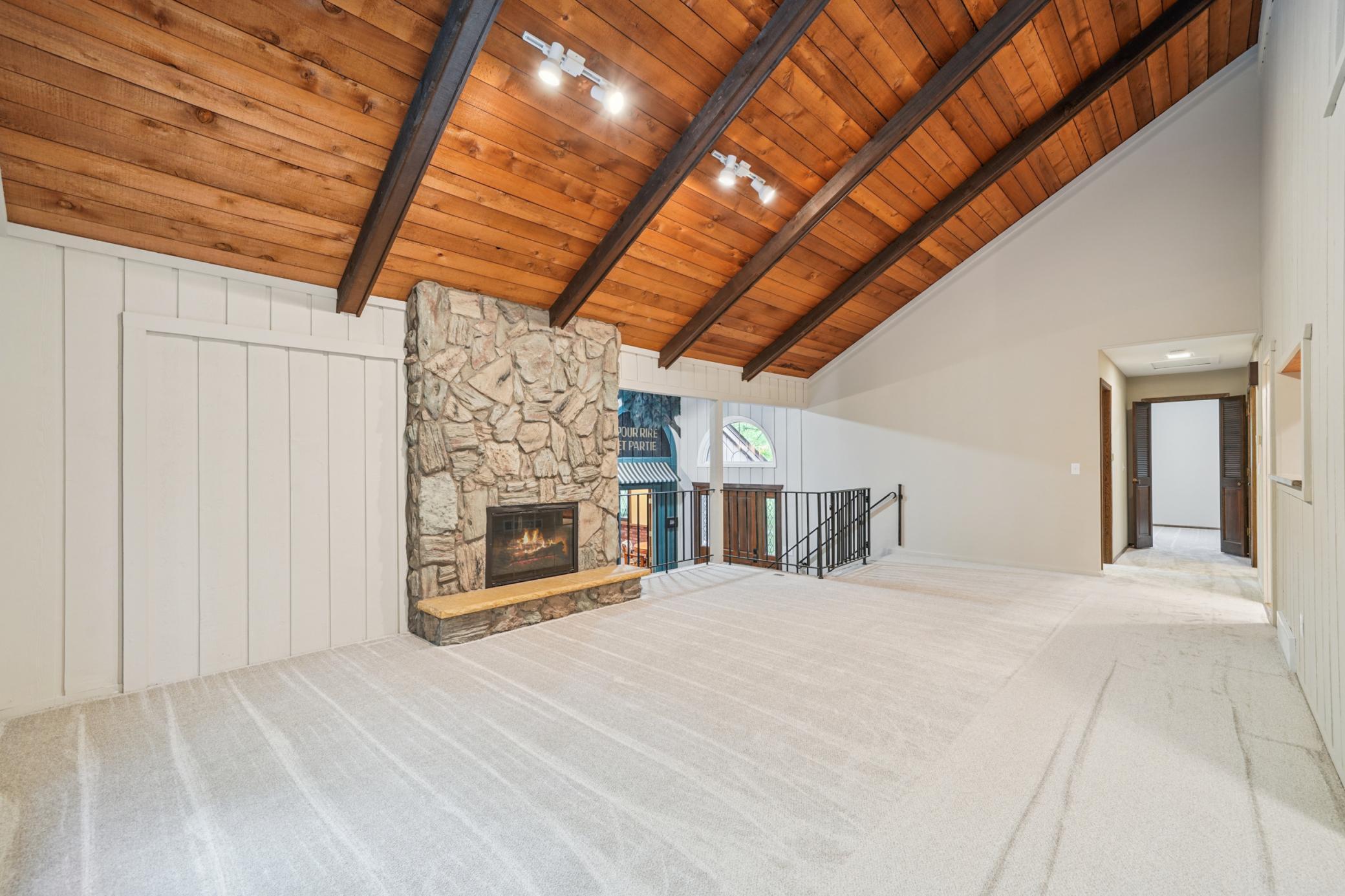 Upper level living room with fireplace